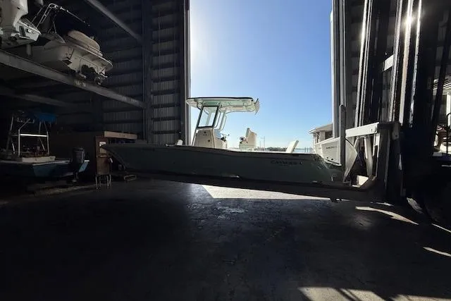  Yacht Photos Pics 2025 Caymas 28 HB boat in storage facility, side view with clear blue sky.