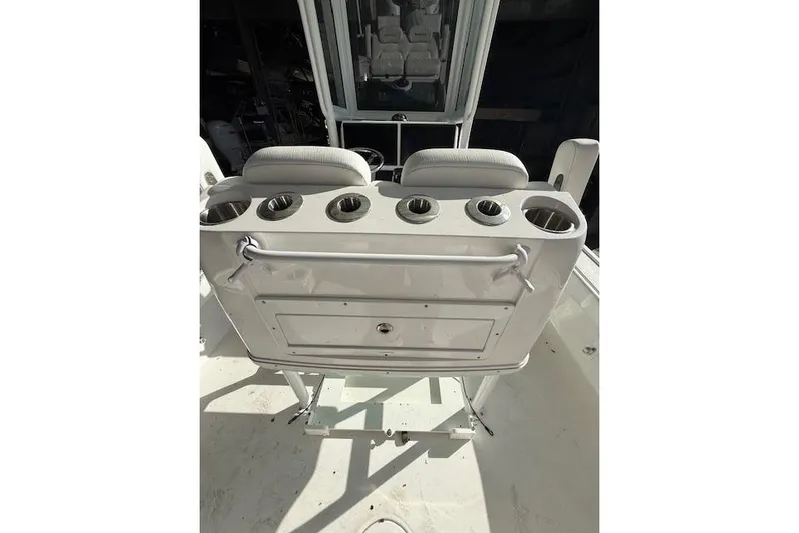  Yacht Photos Pics 2025 Caymas 28 HB boat console with cup holders and seating.