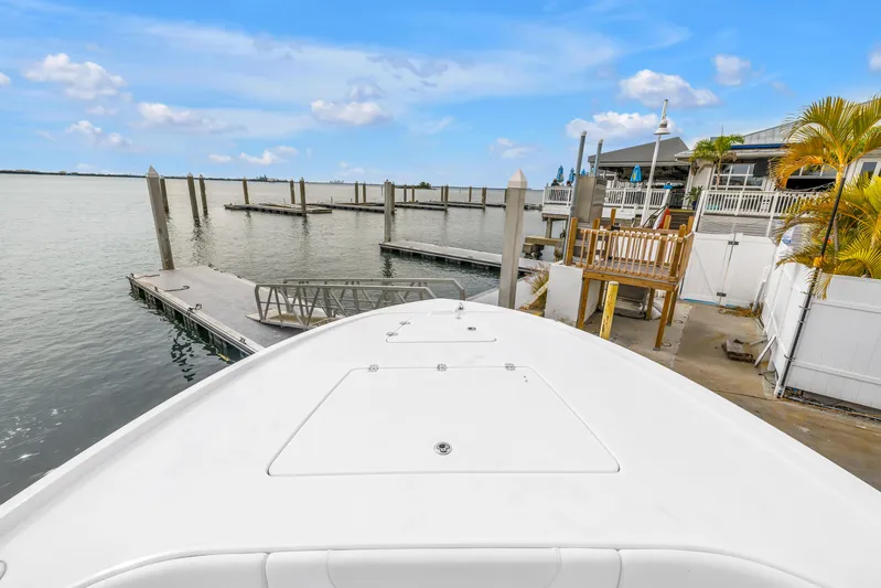  Yacht Photos Pics 2025 Caymas 28 HB boat docked at a marina with clear blue skies.