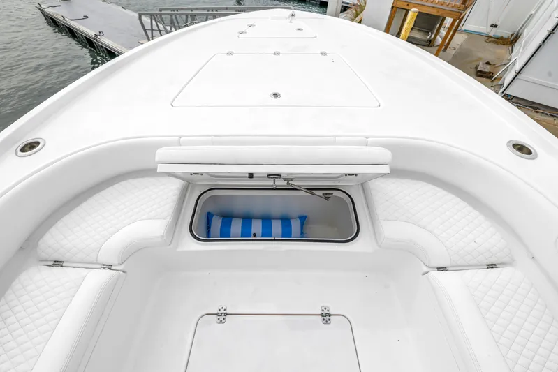  Yacht Photos Pics 2025 Caymas 28 HB boat with open storage compartment and cushioned seating.