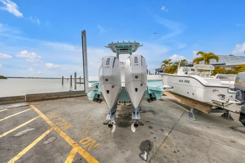  Yacht Photos Pics 2025 Caymas 28 HB boat with dual engines at a marina dock.