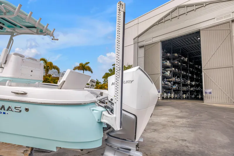  Yacht Photos Pics 2025 Caymas 28 HB boat with Mercury engine near storage facility.