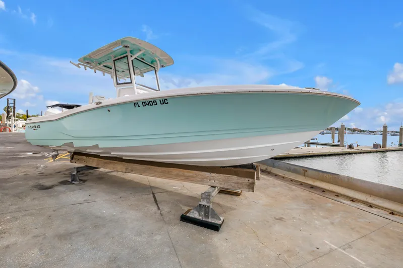  Yacht Photos Pics 2025 Caymas 28 HB boat on dock, light blue hull, clear sky background.