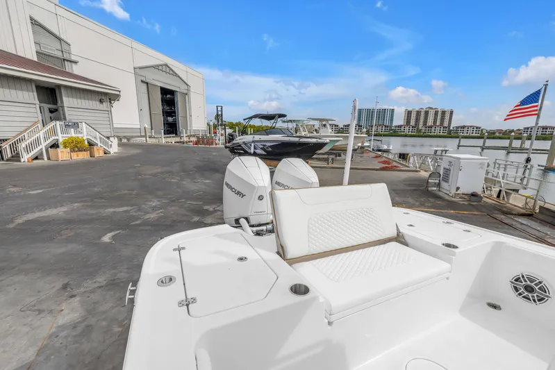  Yacht Photos Pics 2025 Caymas 28 HB boat docked at marina with Mercury engines, American flag visible.