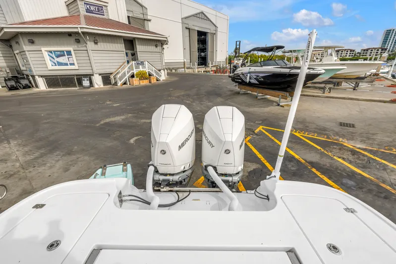  Yacht Photos Pics 2025 Caymas 28 HB boat with dual Mercury engines at a marina dock.
