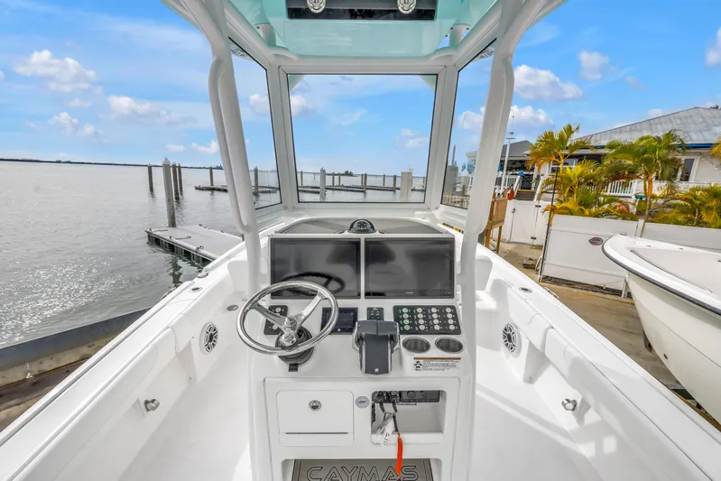  Yacht Photos Pics 2025 Caymas 28 HB boat console with steering wheel and navigation screens at marina.