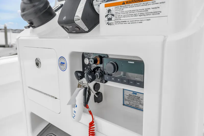  Yacht Photos Pics Control panel of 2025 Caymas 28 HB boat with audio system and safety warnings.