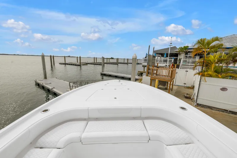  Yacht Photos Pics 2025 Caymas 28 HB boat docked at a marina with clear blue skies.