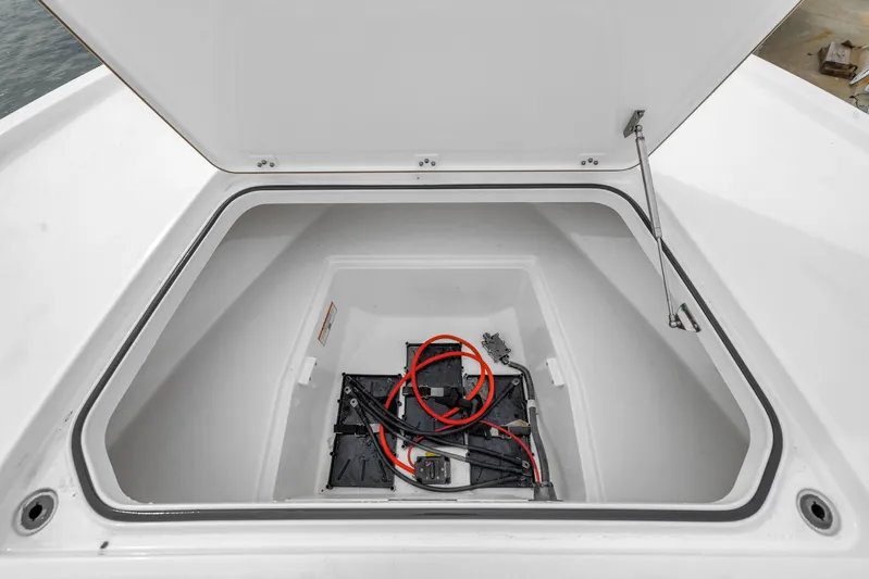  Yacht Photos Pics Open storage compartment in 2025 Caymas 28 HB boat, featuring wiring and battery setup.