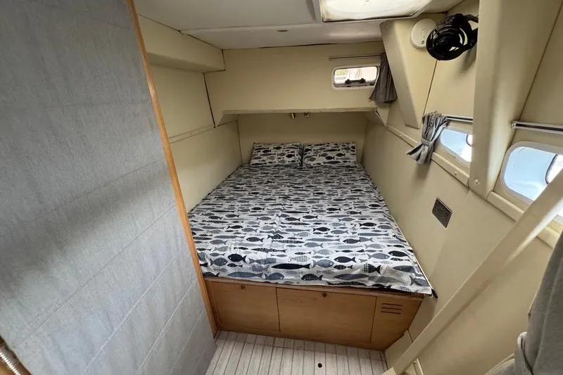 Alita Too Yacht Photos Pics Cozy cabin interior of 2018 Custom COAST 50 boat with fish-patterned bedding.