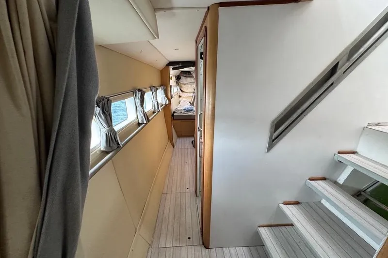 Alita Too Yacht Photos Pics Interior of 2018 Custom COAST 50 yacht, featuring hallway and stairs with windows.