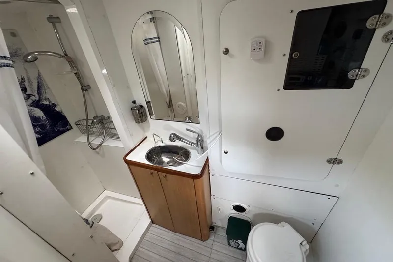 Alita Too Yacht Photos Pics Compact bathroom in 2018 Custom COAST 50, featuring shower, sink, and toilet.