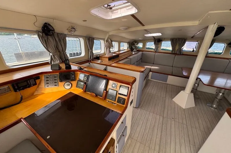 Alita Too Yacht Photos Pics Interior of 2018 Custom COAST 50 yacht with navigation equipment and seating area.