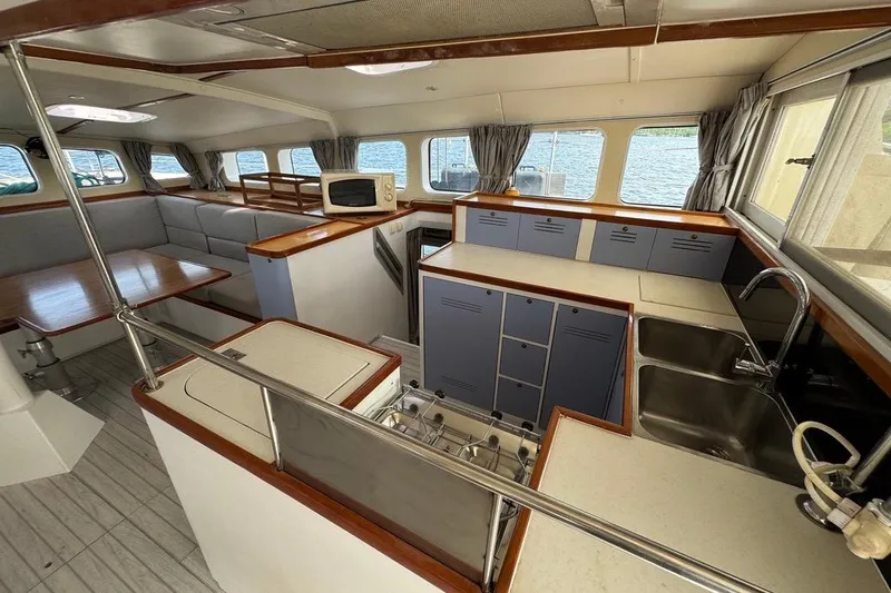 Alita Too Yacht Photos Pics Spacious interior of 2018 Custom COAST 50 yacht with modern kitchen and dining area.