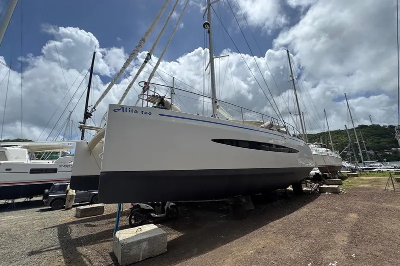 Alita Too Yacht Photos Pics Custom COAST 50 catamaran from 2018 on land, under a partly cloudy sky.