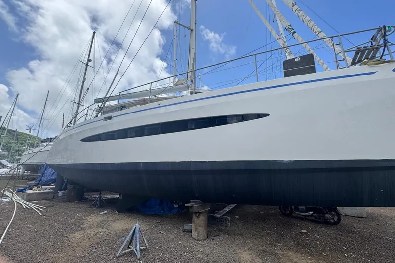 Alita Too Yacht Photos Pics Custom COAST 50 sailboat from 2018 on dry dock, under a partly cloudy sky.