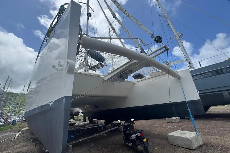 Alita Too Yacht Photos Pics Custom COAST 50 catamaran, 2018 model, docked on land with clear blue sky.
