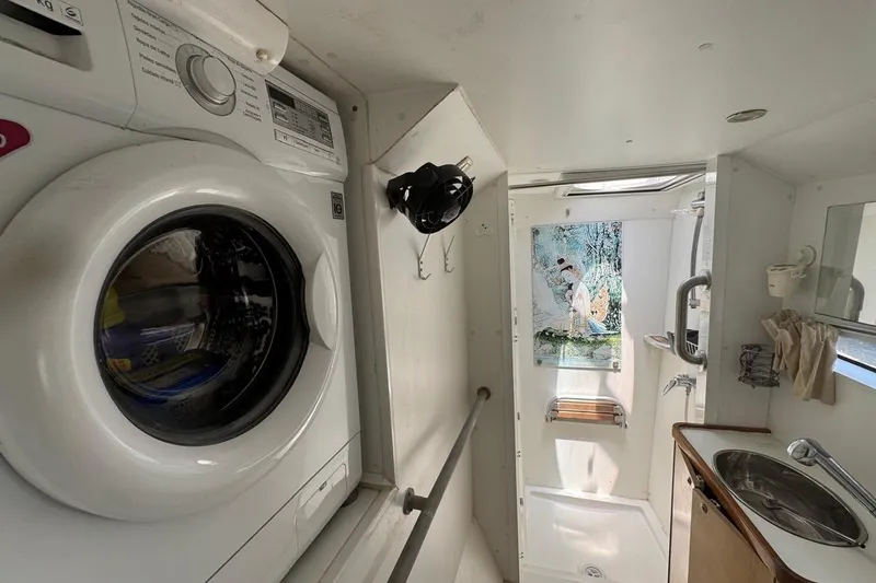 Alita Too Yacht Photos Pics Compact bathroom in 2018 Custom COAST 50 with washer, shower, and sink.