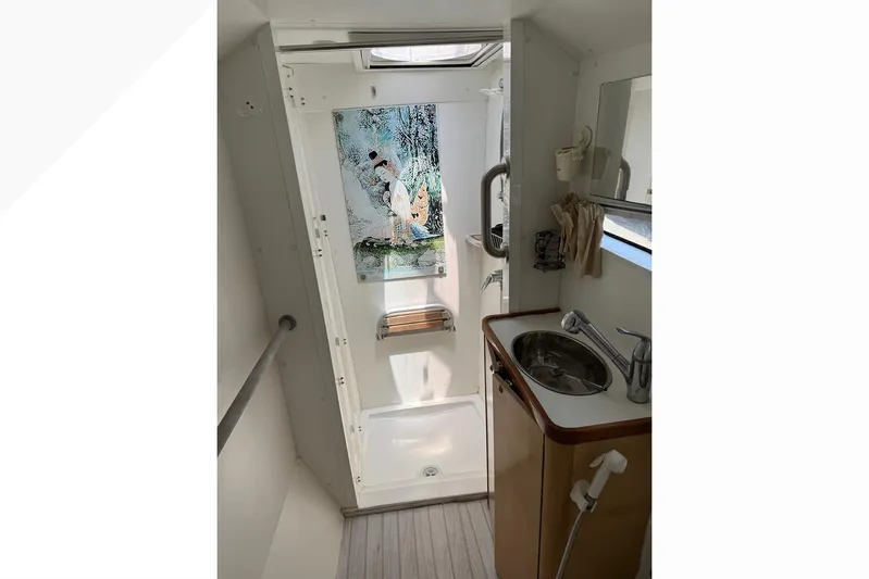 Alita Too Yacht Photos Pics Compact bathroom in 2018 Custom COAST 50 boat with shower, sink, and decorative wall art.