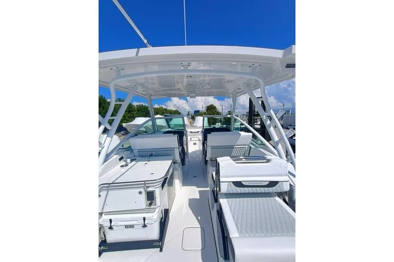 302-126 Yacht Photos Pics 2025 Blackfin 302 DC boat interior with seating and storage, under a clear blue sky.