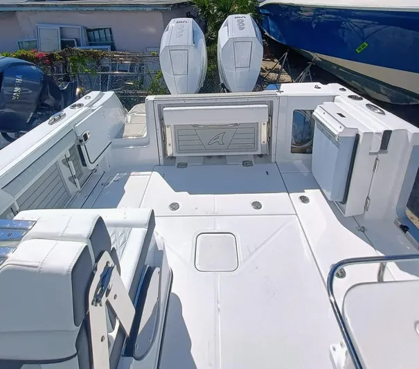 302-126 Yacht Photos Pics 2025 Blackfin 302 DC boat deck with dual engines and seating area.