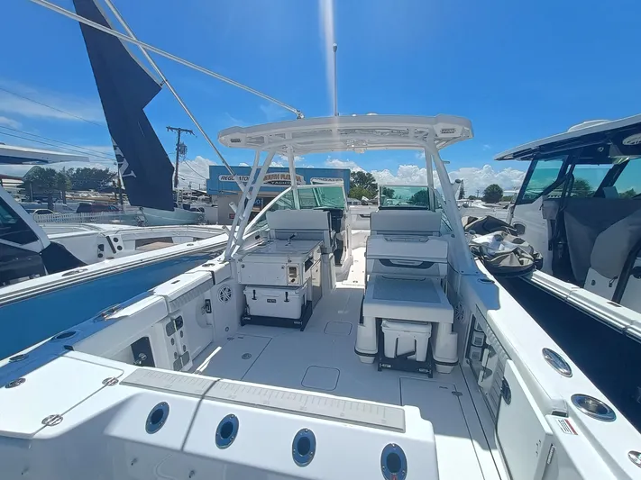 302-126 Yacht Photos Pics 2025 Blackfin 302 DC boat interior with seating and storage, under a clear blue sky.