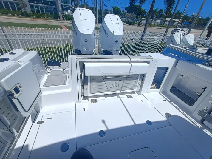 302-126 Yacht Photos Pics 2025 Blackfin 302 DC boat deck with dual Mercury engines, white interior, and storage compartments.