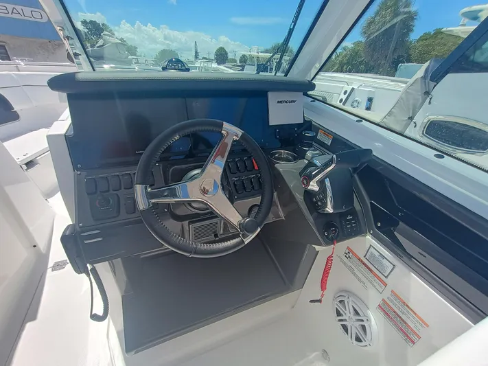 302-126 Yacht Photos Pics 2025 Blackfin 302 DC boat cockpit with steering wheel and control panel.
