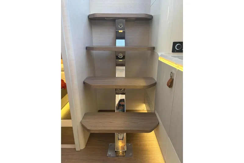  Yacht Photos Pics Modern wooden staircase inside 2026 Level Yachts 43 STS, featuring sleek design and ambient lighting.