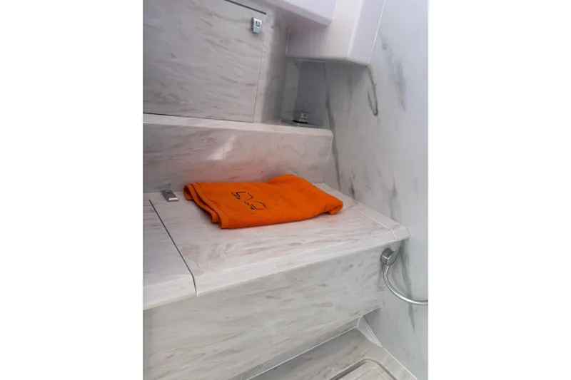  Yacht Photos Pics Luxurious interior of 2026 Level Yachts 43 STS with orange towel on marble surface.