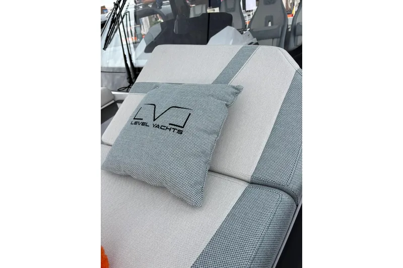  Yacht Photos Pics Cushioned seating on 2026 Level Yachts 43 STS, featuring branded pillow and modern design.