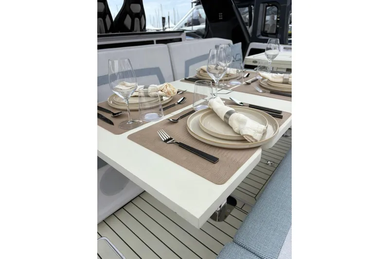  Yacht Photos Pics Elegant dining setup on 2026 Level Yachts 43 STS, featuring stylish tableware and glassware.