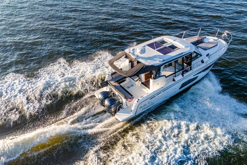 Bella Thalassa Yacht Photos Pics 2021 Jeanneau NC 1095 cruising on open water, showcasing sleek design and powerful engines.
