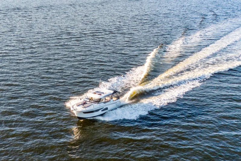 Bella Thalassa Yacht Photos Pics Aerial view of 2021 Jeanneau NC 1095 cruising on open water.