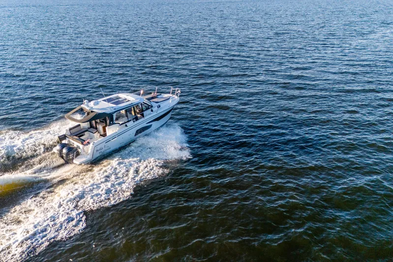 Bella Thalassa Yacht Photos Pics 2021 Jeanneau NC 1095 cruising on open water, aerial view.