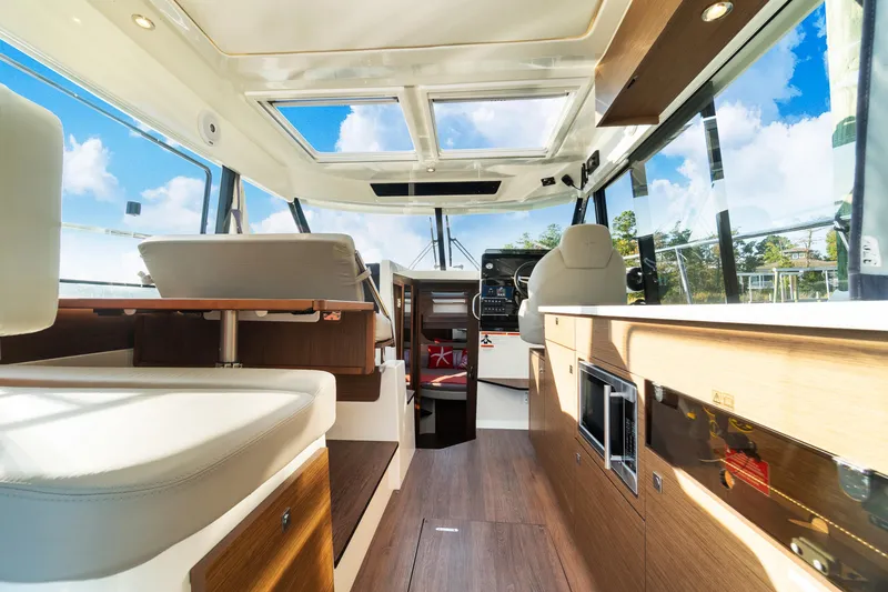 Bella Thalassa Yacht Photos Pics Interior of 2021 Jeanneau NC 1095 boat with modern design and panoramic windows.