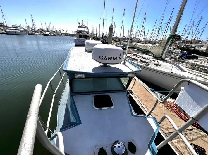 Acb Yacht Photos Pics Boat docked at marina, featuring Garmin equipment, surrounded by sailboats.