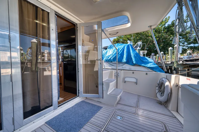 #r Dream Yacht Photos Pics Mainship 400 Trawler 2005, interior view with open door and deck.