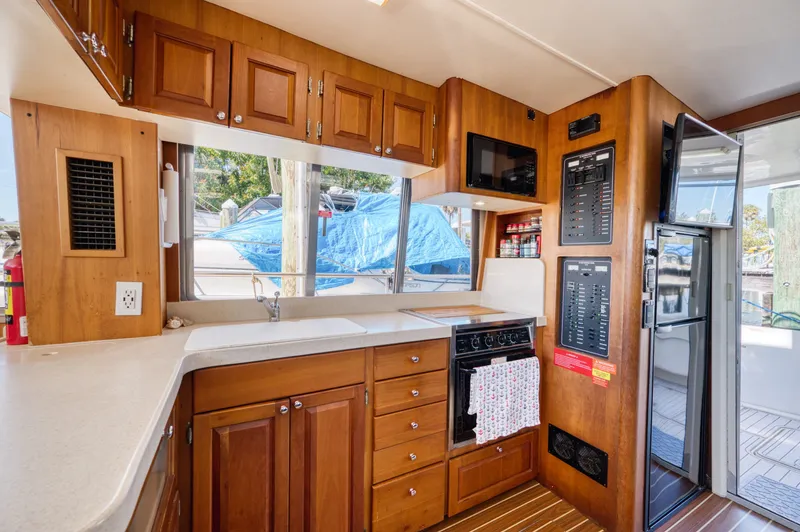#r Dream Yacht Photos Pics Mainship 400 Trawler 2005 kitchen with wooden cabinets and appliances.