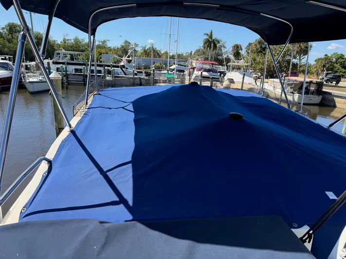 #r Dream Yacht Photos Pics 2005 Mainship 400 Trawler with blue cover in marina.