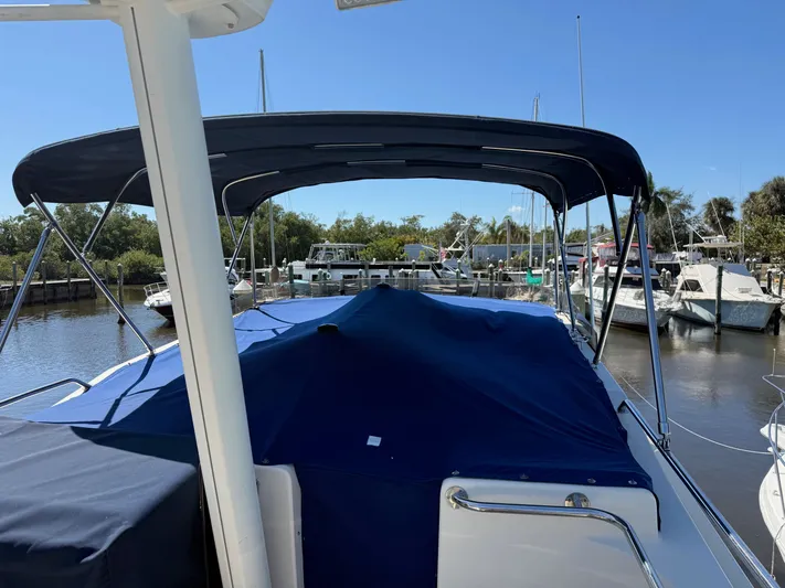 #r Dream Yacht Photos Pics 2005 Mainship 400 Trawler docked with blue cover.