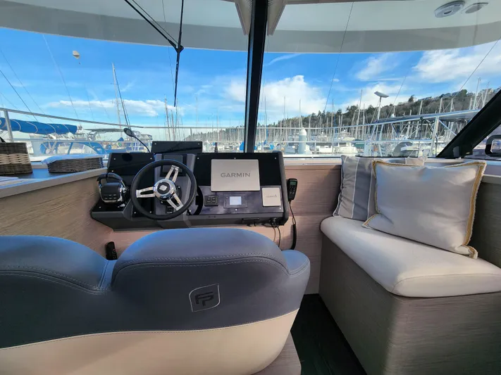 Emily Yacht Photos Pics Interior of 2022 Fountaine Pajot MY4.S yacht with steering wheel and navigation system.