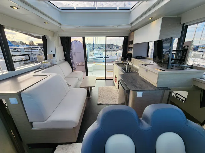 Emily Yacht Photos Pics Luxurious interior of 2022 Fountaine Pajot MY4.S yacht with modern furnishings and marina view.