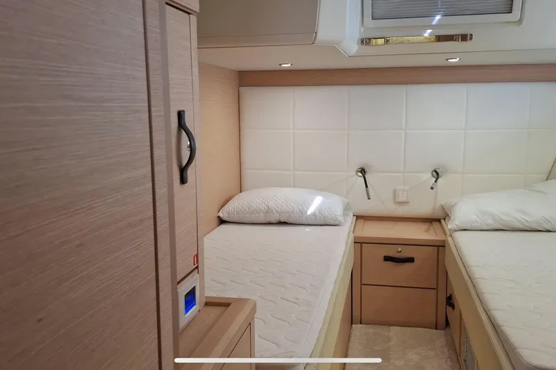  Yacht Photos Pics Interior cabin of 2016 Jeanneau 64 yacht with twin beds and modern design.