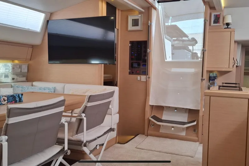  Yacht Photos Pics Luxurious interior of a 2016 Jeanneau 64 yacht with modern furnishings and a large TV.