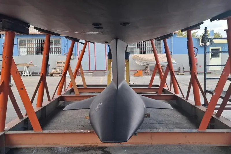  Yacht Photos Pics 2016 Jeanneau 64 yacht keel in dry dock, supported by orange stands.