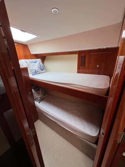 New Listing Yacht Photos Pics 2016 Riviera 45 Open Flybridge cabin with bunk beds and wooden interior.
