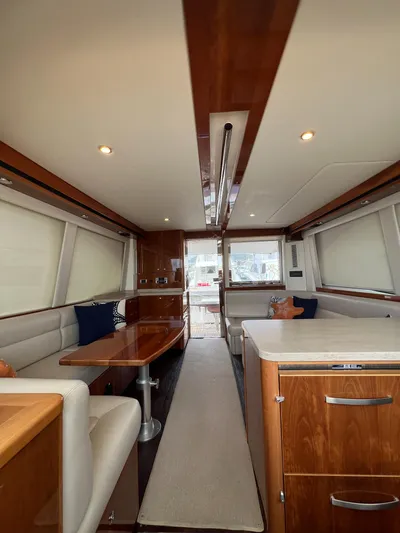 New Listing Yacht Photos Pics Luxurious interior of 2016 Riviera 45 Open Flybridge yacht with elegant wood finishes.