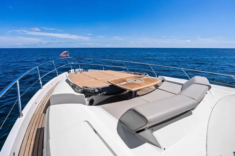 Blue Daksa Yacht Photos Pics Luxurious 2013 Absolute 64 yacht deck with sunbeds, table, and ocean view.