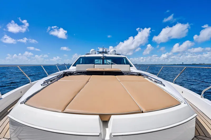 Blue Daksa Yacht Photos Pics Luxurious 2013 Absolute 64 yacht with sunbathing deck on open sea under blue sky.